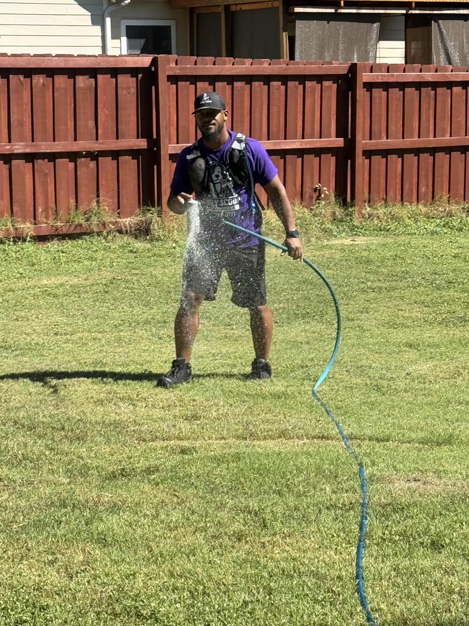 Man watering lawn with hose