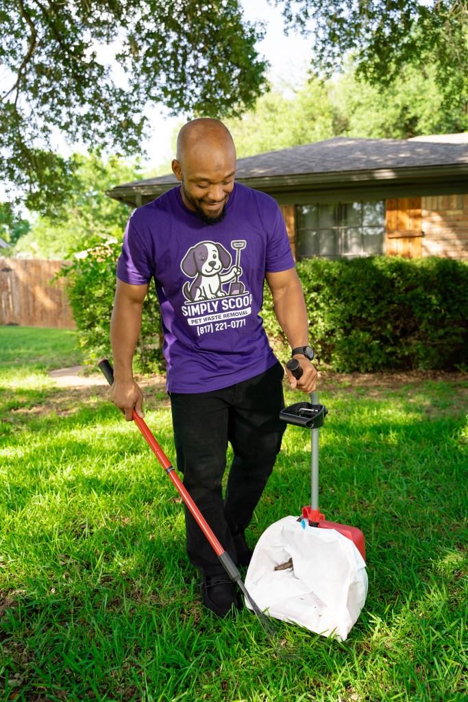 Pooper Scooper Simply Scoop technician scooping pet waste from a residential backyard lawn.